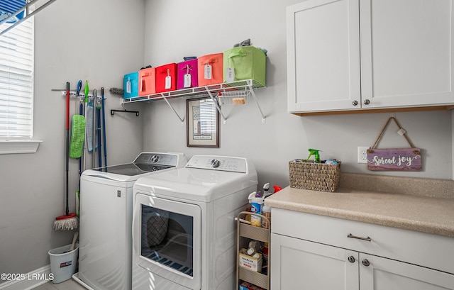 laundry room featuring cabinets and washer and clothes dryer