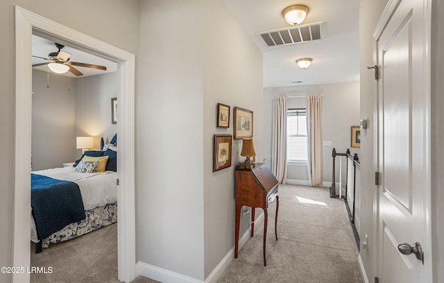 hallway featuring light carpet