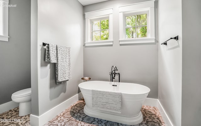 213 Old Plantation Dr W, Beaufort, SC 29907 - full bathroom with baseboards, a soaking tub, toilet, and tile patterned floors