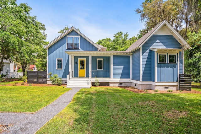213 Old Plantation Dr W, Beaufort, SC 29907 - view of front facade with crawl space, board and batten siding, covered porch, and a front lawn