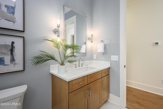 bathroom with vanity, hardwood / wood-style floors, and toilet