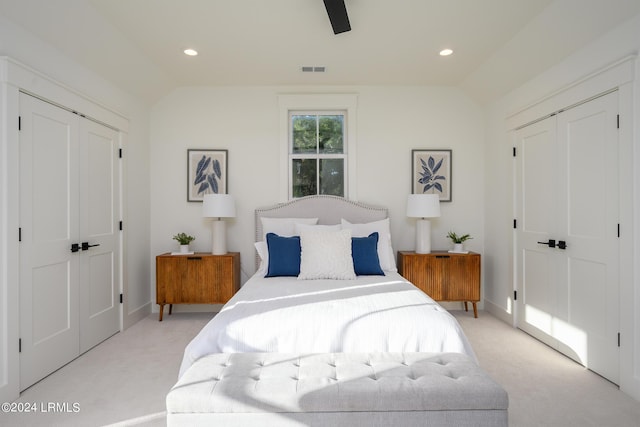 bedroom with vaulted ceiling, light colored carpet, and ceiling fan