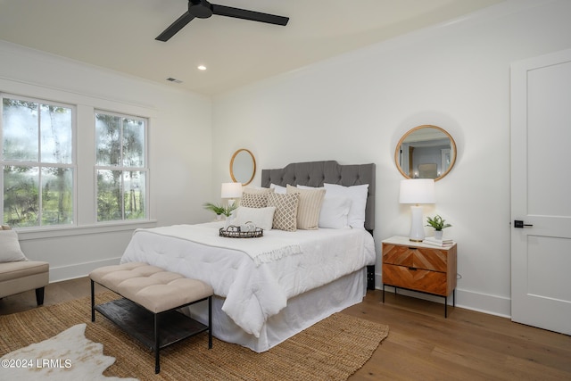 bedroom featuring crown molding, ceiling fan, and hardwood / wood-style floors