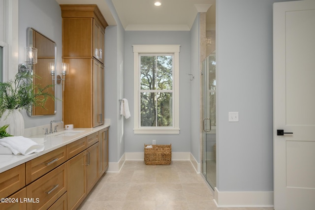 bathroom featuring a shower with door, vanity, and ornamental molding