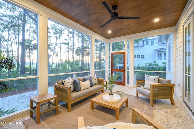 sunroom / solarium with ceiling fan, a healthy amount of sunlight, and wood ceiling