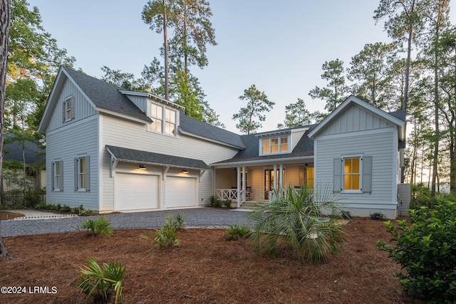 view of front facade featuring a porch and a garage