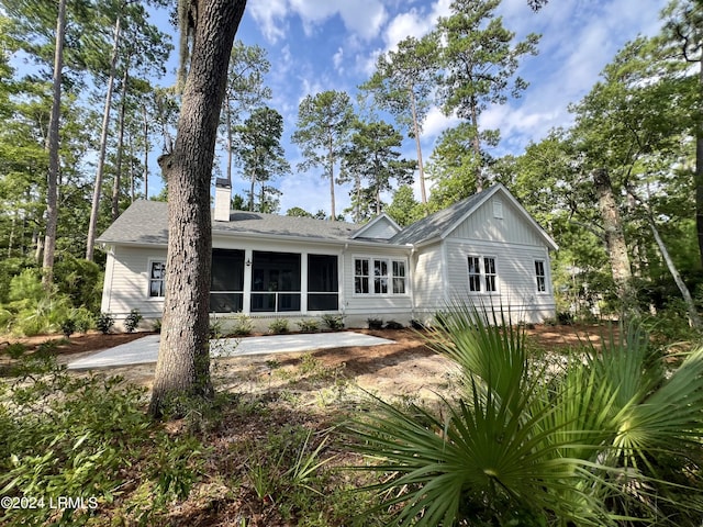 rear view of property featuring a patio area and a sunroom