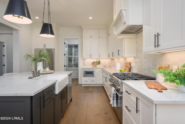 kitchen featuring pendant lighting, white cabinets, and appliances with stainless steel finishes