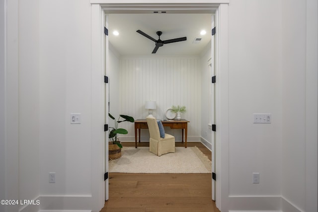 hallway with hardwood / wood-style flooring