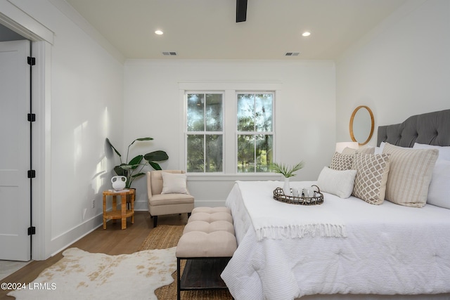 bedroom featuring crown molding and wood-type flooring