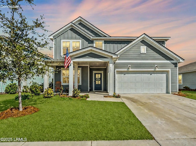 view of front of home featuring a garage, driveway, a lawn, a porch, and board and batten siding