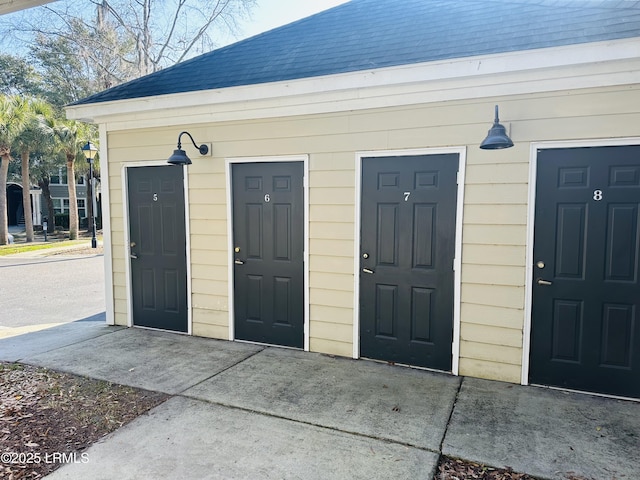 exterior space featuring a shingled roof