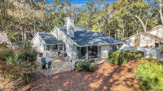 rear view of house with a patio and central AC