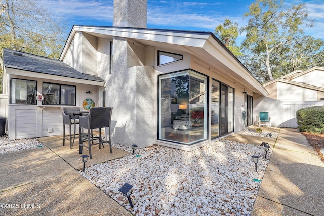 back of house with a patio