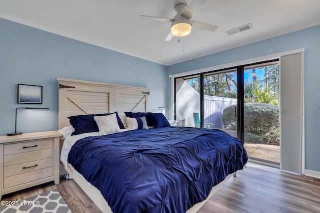 bedroom featuring ceiling fan, ornamental molding, wood-type flooring, and access to outside