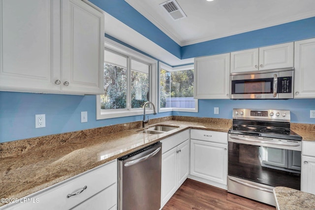 kitchen featuring light stone counters, appliances with stainless steel finishes, sink, and white cabinets