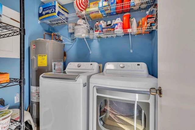 laundry room featuring electric water heater and washer and dryer