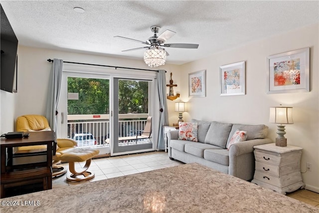 tiled living room with ceiling fan and a textured ceiling