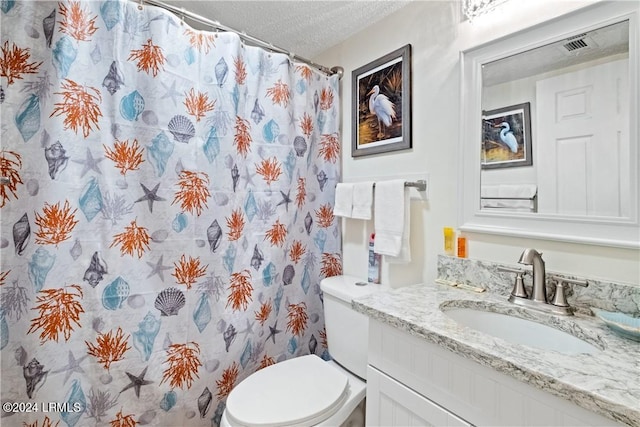 bathroom featuring vanity, toilet, a textured ceiling, and walk in shower