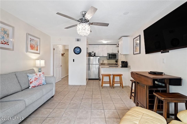 living room featuring light tile patterned flooring and ceiling fan