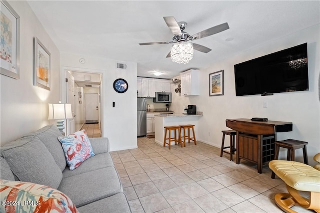 tiled living room featuring ceiling fan