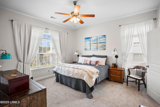 bedroom featuring light colored carpet, visible vents, ceiling fan, and baseboards