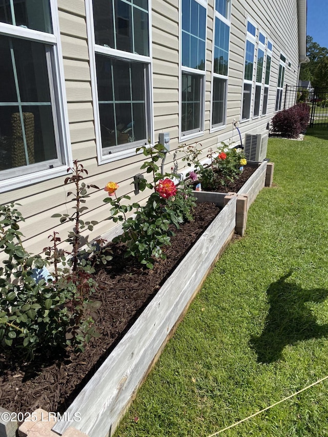 details with central AC, a vegetable garden, and fence