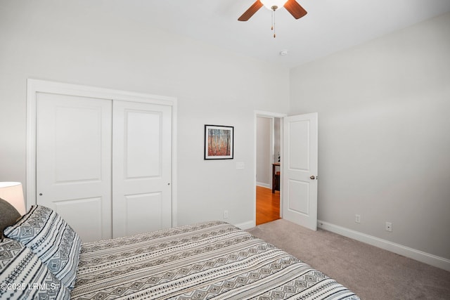 bedroom with a ceiling fan, carpet, a closet, and baseboards