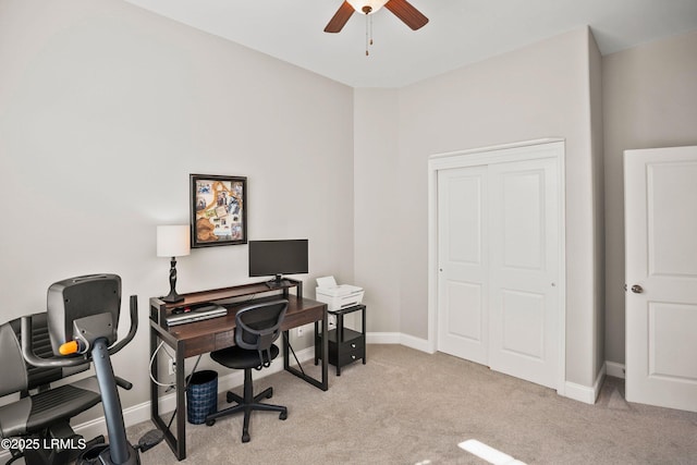 office space with light carpet, ceiling fan, and baseboards