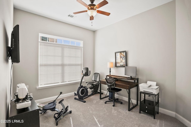 carpeted office space with a ceiling fan, visible vents, and baseboards