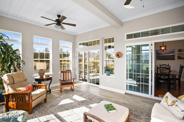 sunroom / solarium with wooden ceiling, plenty of natural light, beam ceiling, and a ceiling fan