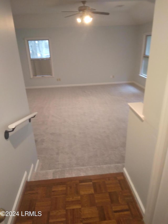 empty room featuring ceiling fan and baseboards