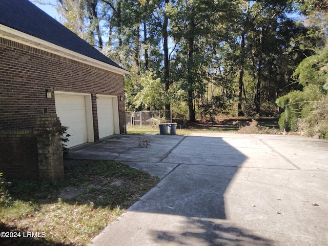 view of patio / terrace featuring a garage and driveway