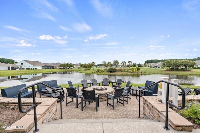 view of dock featuring a patio, a water view, and an outdoor fire pit