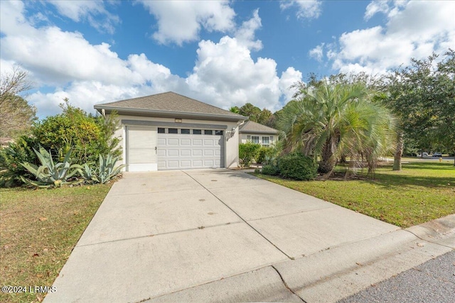 view of front of house with a garage and a front yard