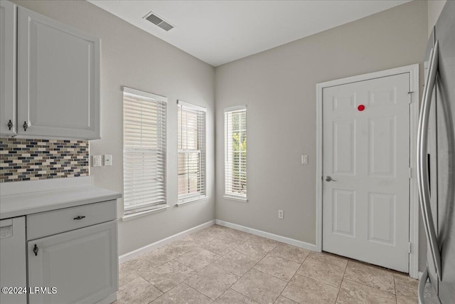 unfurnished dining area with light tile patterned floors