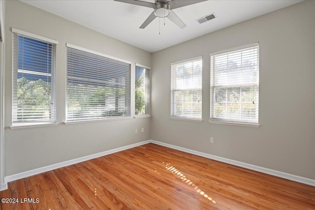 empty room featuring hardwood / wood-style floors and ceiling fan