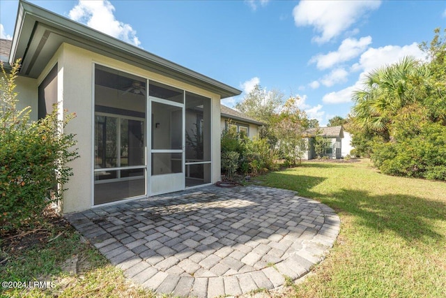 view of yard featuring a patio area and a sunroom