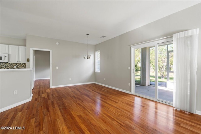 interior space with hardwood / wood-style floors and a chandelier