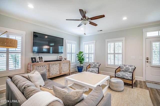 living room featuring ceiling fan, ornamental molding, and hardwood / wood-style floors