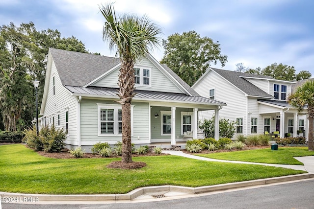 view of front of home with a front yard and covered porch