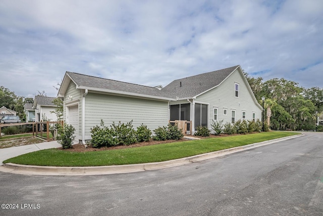 view of home's exterior with a garage and a yard