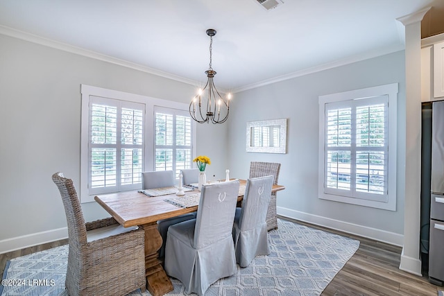 dining area with crown molding, dark hardwood / wood-style floors, and a chandelier