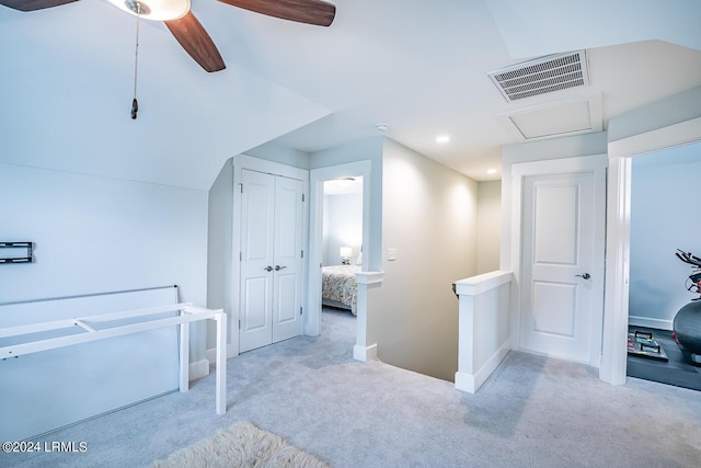 bonus room with lofted ceiling and light carpet