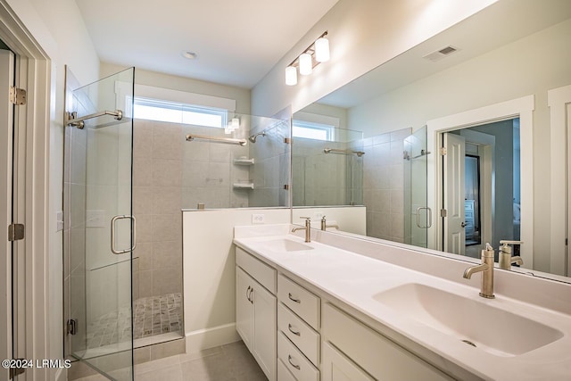 bathroom with vanity, a shower with shower door, and tile patterned flooring