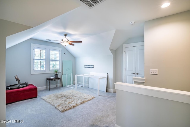 bedroom featuring vaulted ceiling, light colored carpet, ceiling fan, and a closet