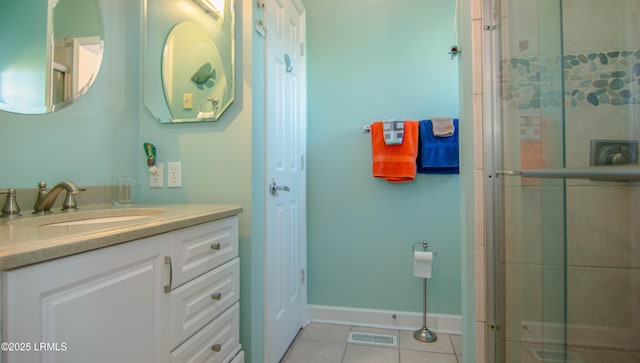 full bathroom featuring visible vents, a tile shower, tile patterned flooring, and vanity