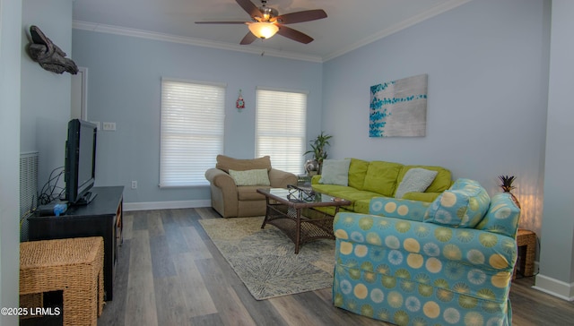 living area featuring ornamental molding, ceiling fan, wood finished floors, and baseboards