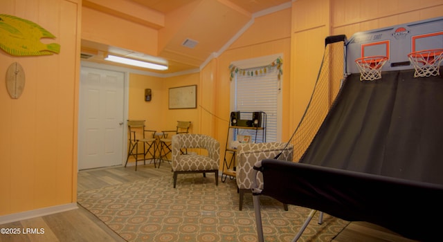 sitting room with wood finished floors and lofted ceiling