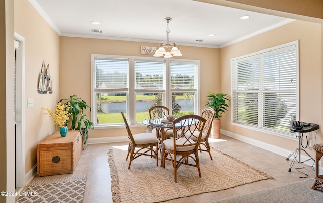 dining area with ornamental molding, a water view, and an inviting chandelier